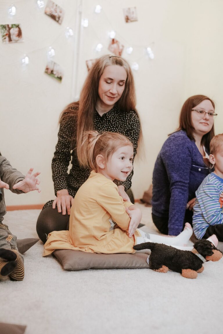 Children and their mothers enjoy a nurturing preschool environment engaged in learning and play.