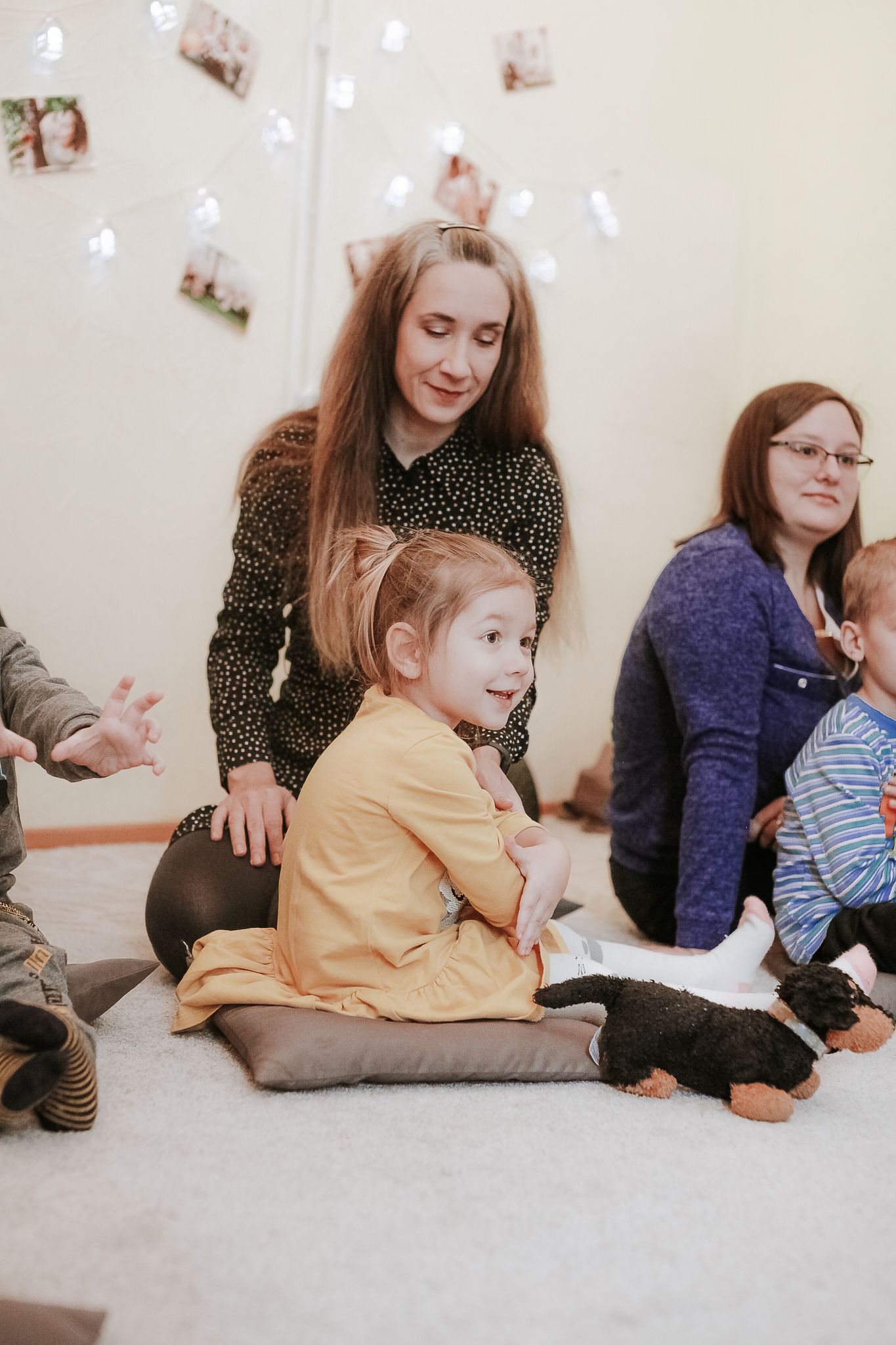 Children and their mothers enjoy a nurturing preschool environment engaged in learning and play.